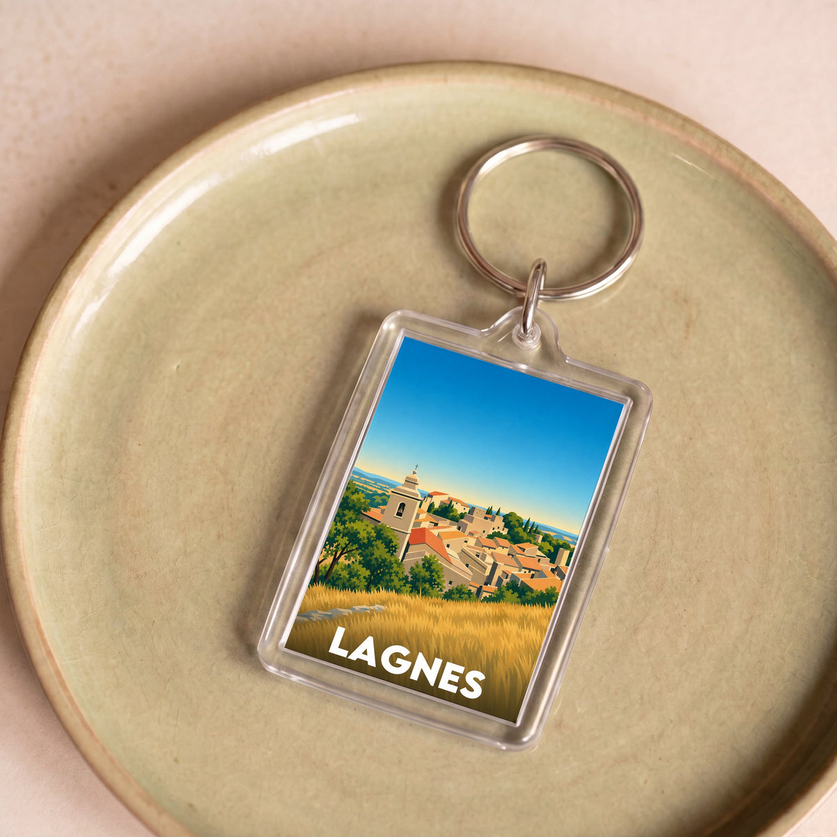 Porte-clés souvenir de la ville de Lagnes avec une illustration stylisée du village.
