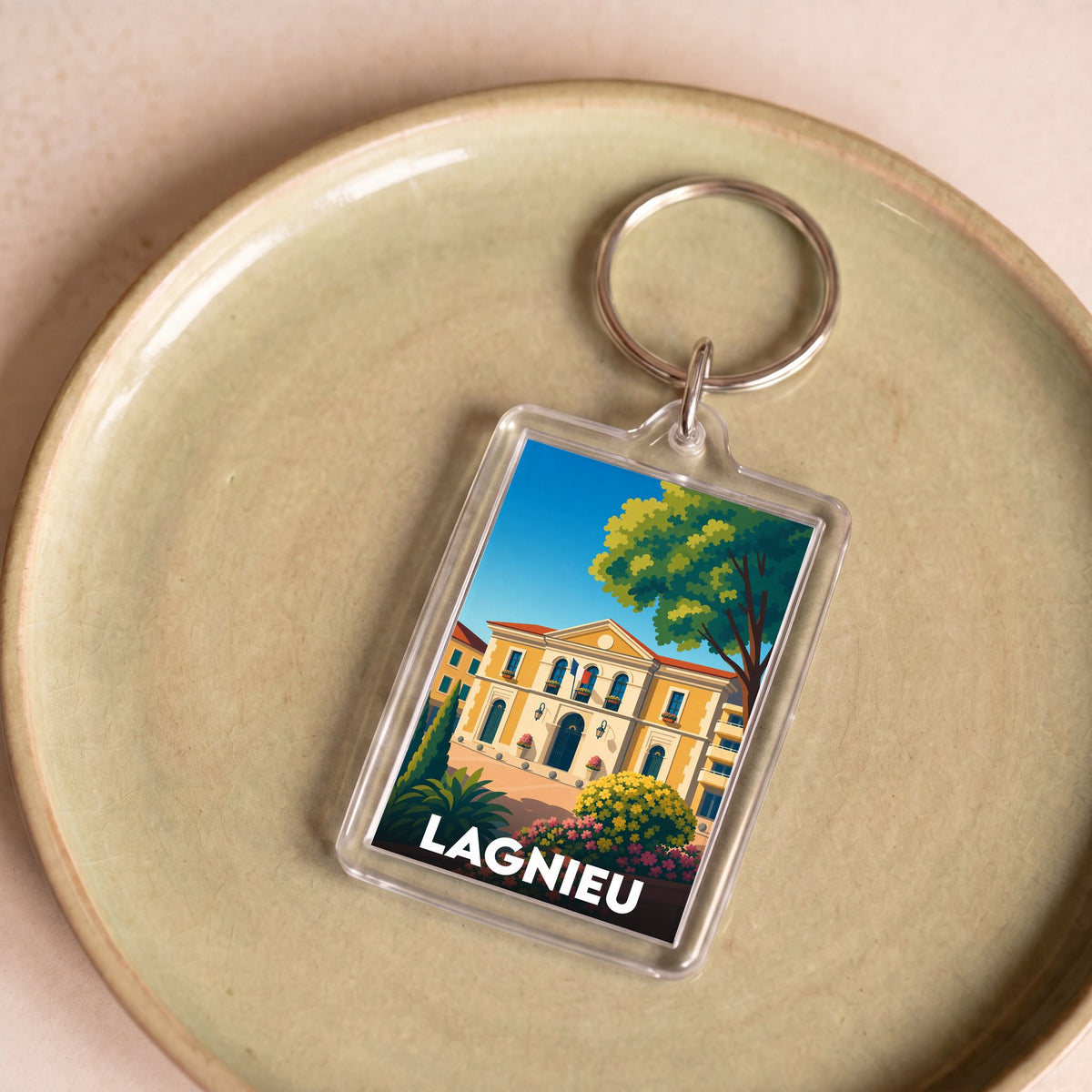 Porte-clés souvenir de la ville de Lagnieu avec une illustration stylisée.