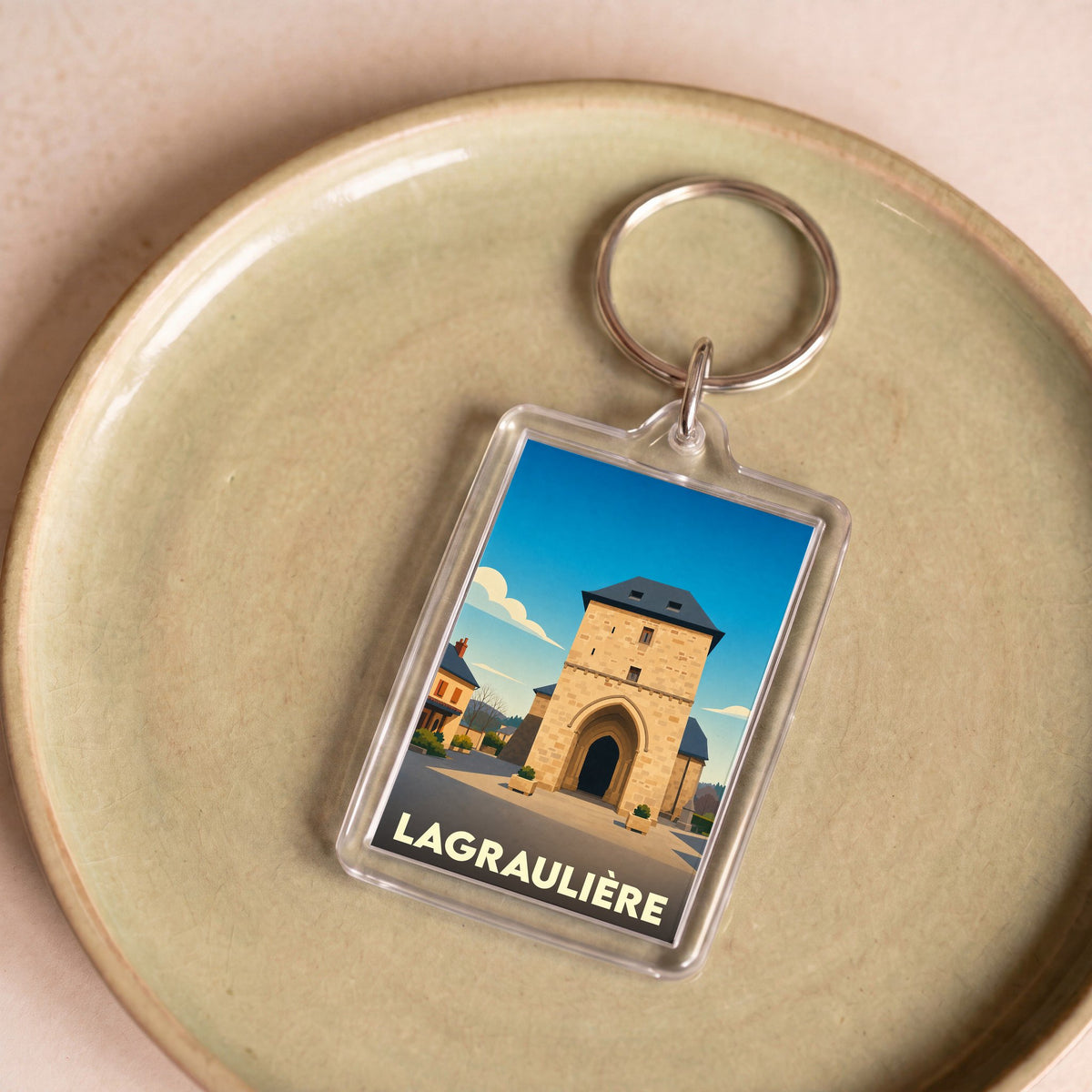 Porte-clés souvenir de la ville de Lagraulière avec une illustration stylisée.