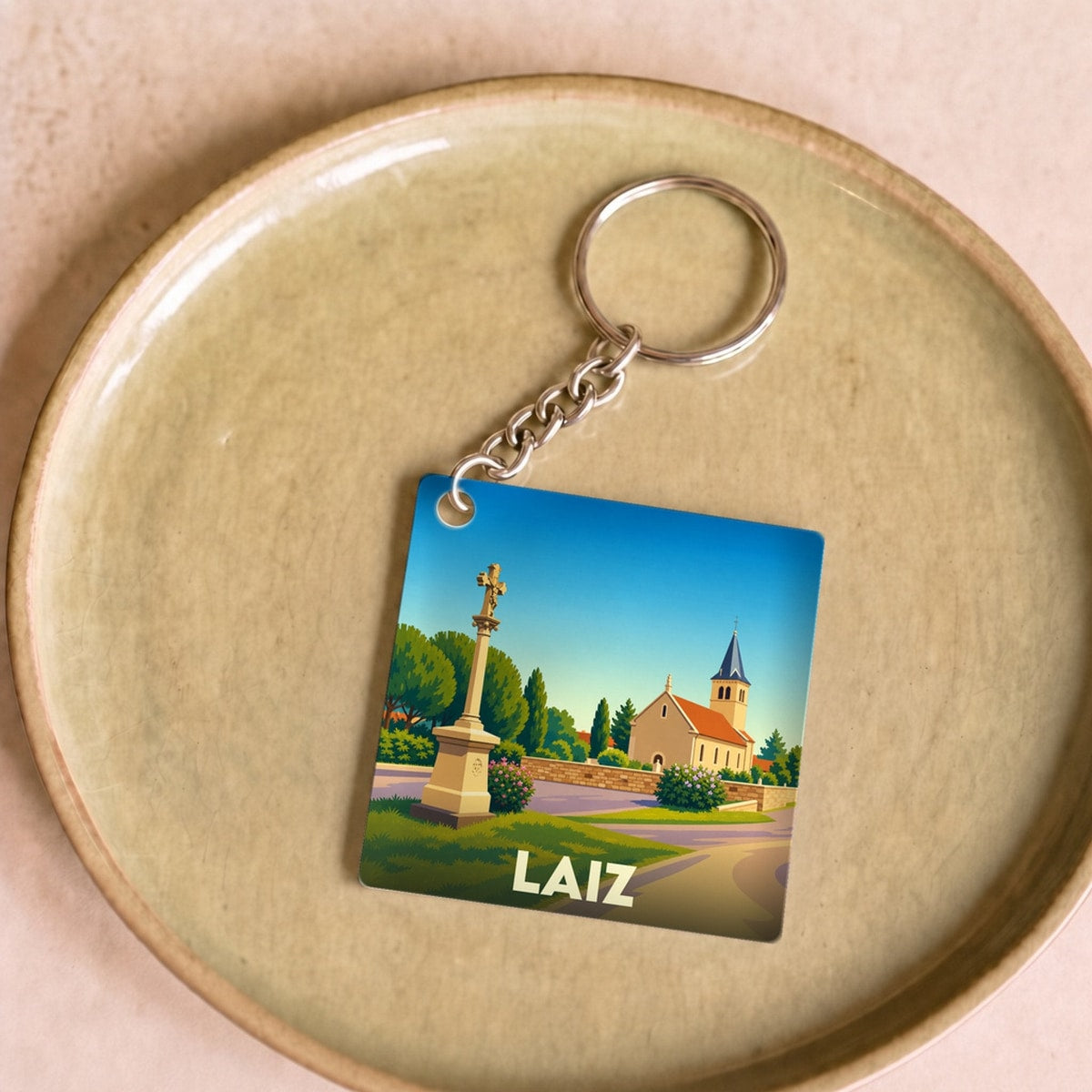Porte-clés souvenir de la ville de Laiz avec une illustration stylisée.