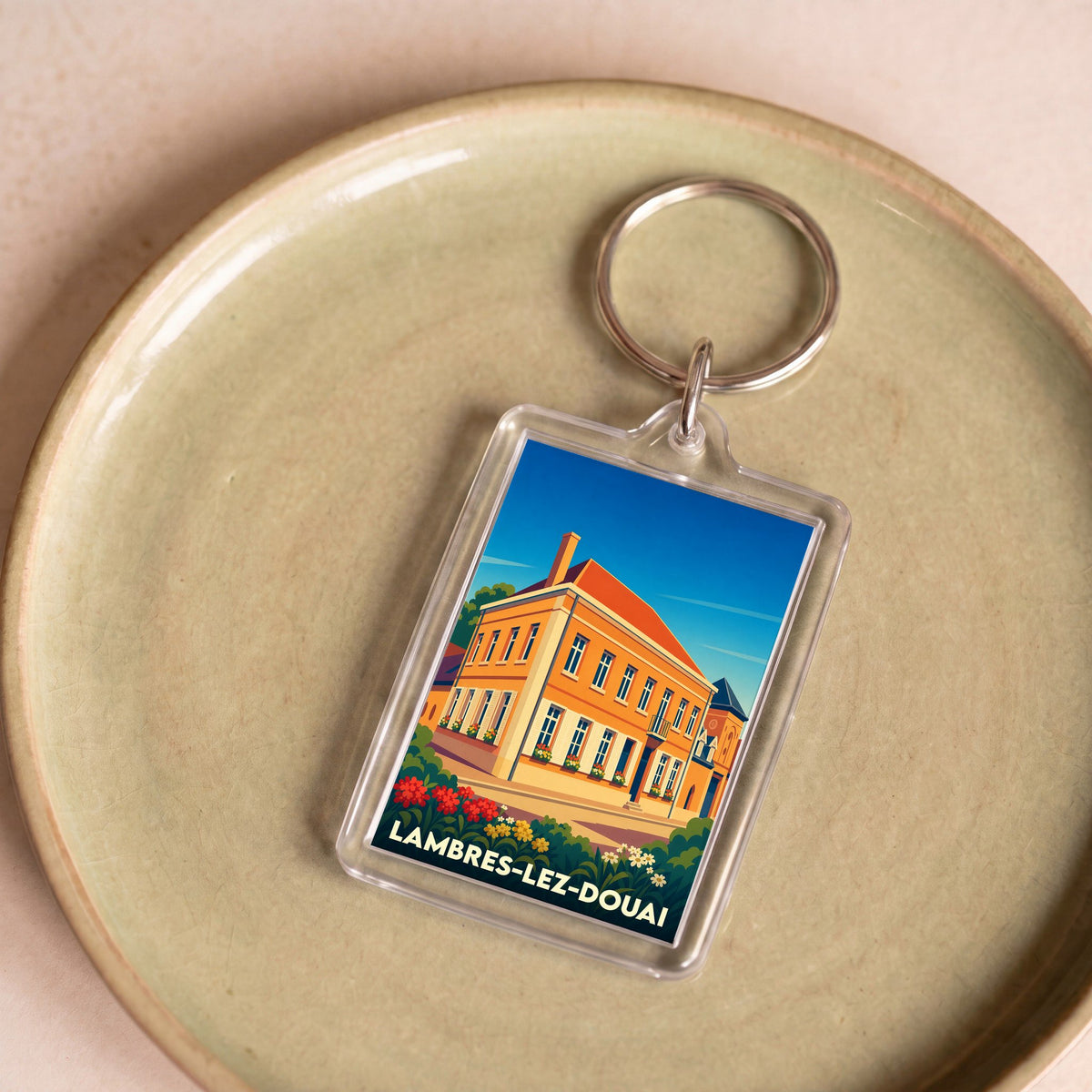 Porte-clés souvenir de la ville de Lambres-lez-Douai avec une illustration colorée et stylisée.