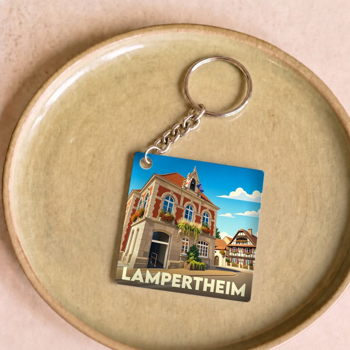 Porte-clés souvenir de la ville de Lampertheim avec une illustration stylisée.