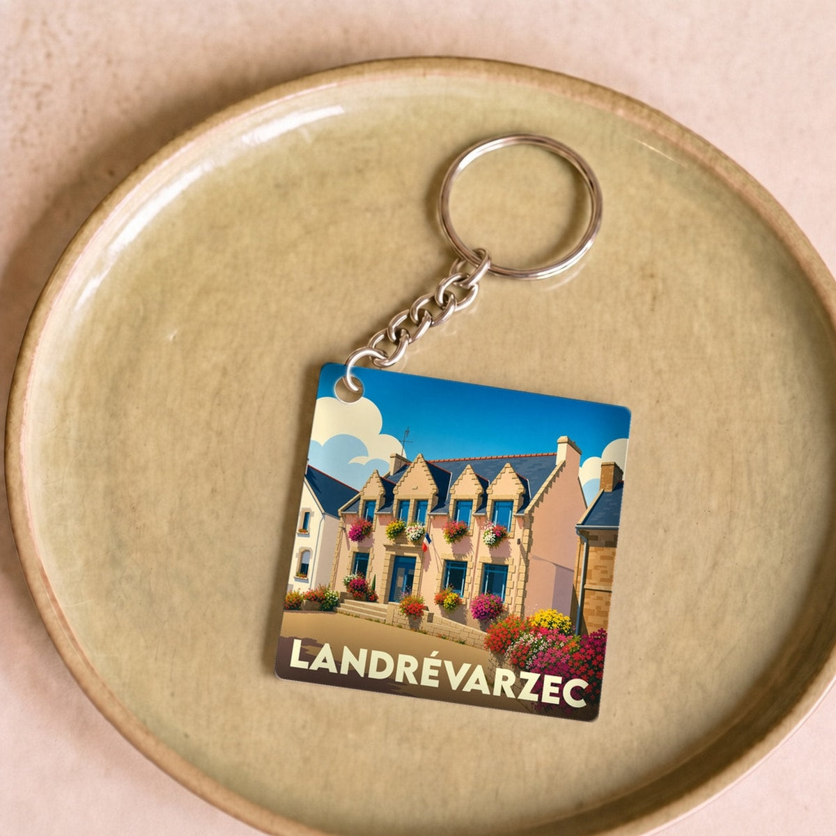 Porte-clés souvenir de la ville de Landrévarzec avec une illustration stylisée.