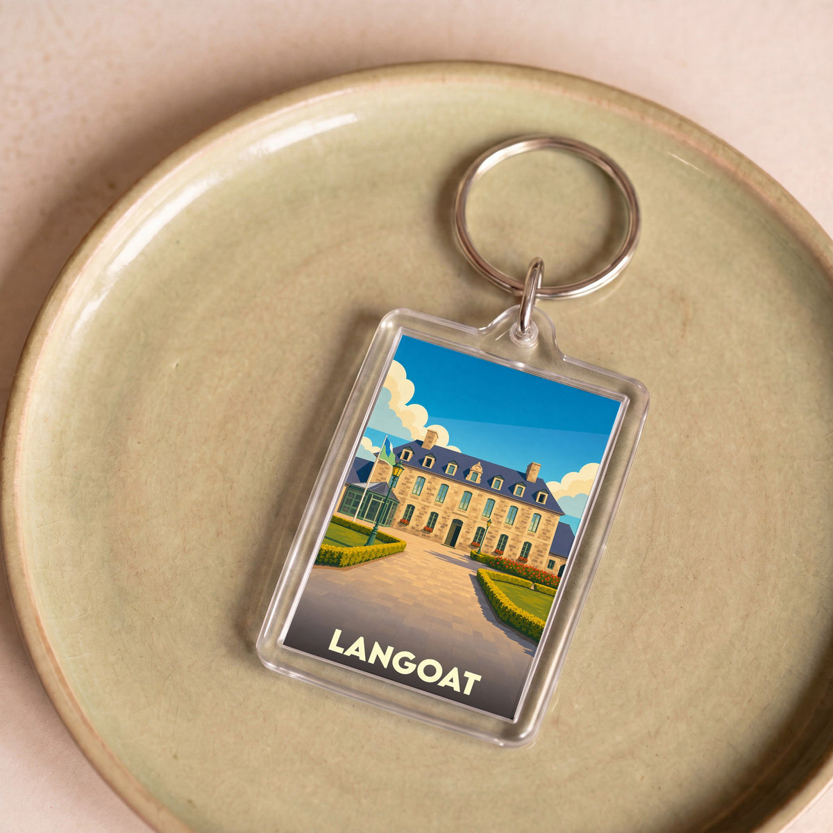 Porte-clés souvenir de la ville de Langoat avec une illustration stylisée d'un bâtiment historique.