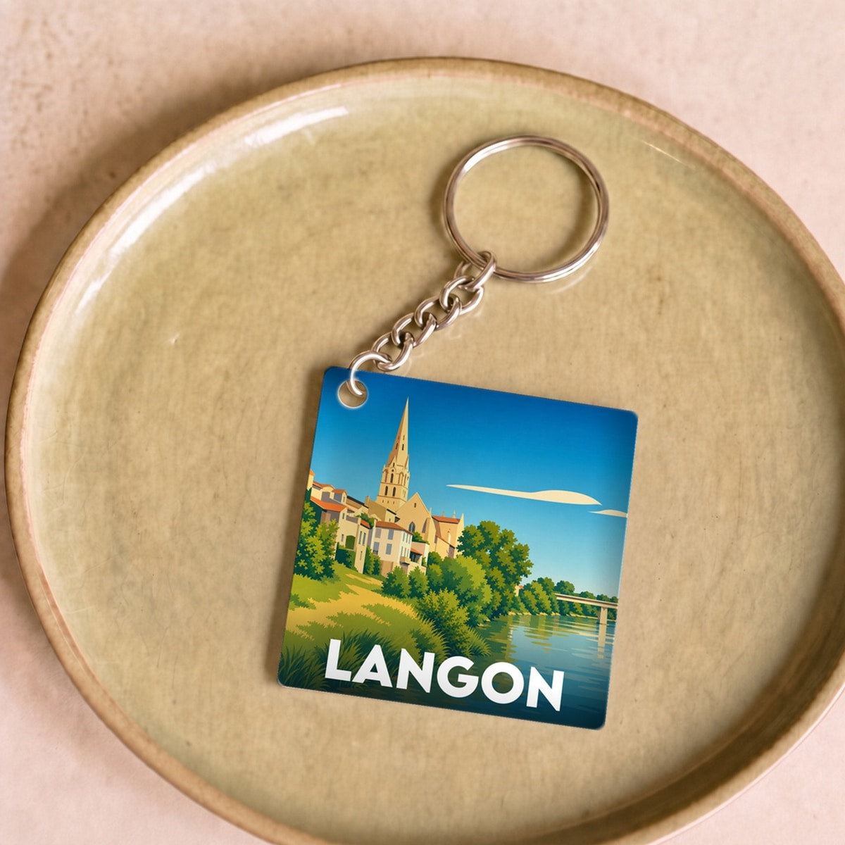 Porte-clés souvenir de la ville de Langon avec une illustration stylisée.