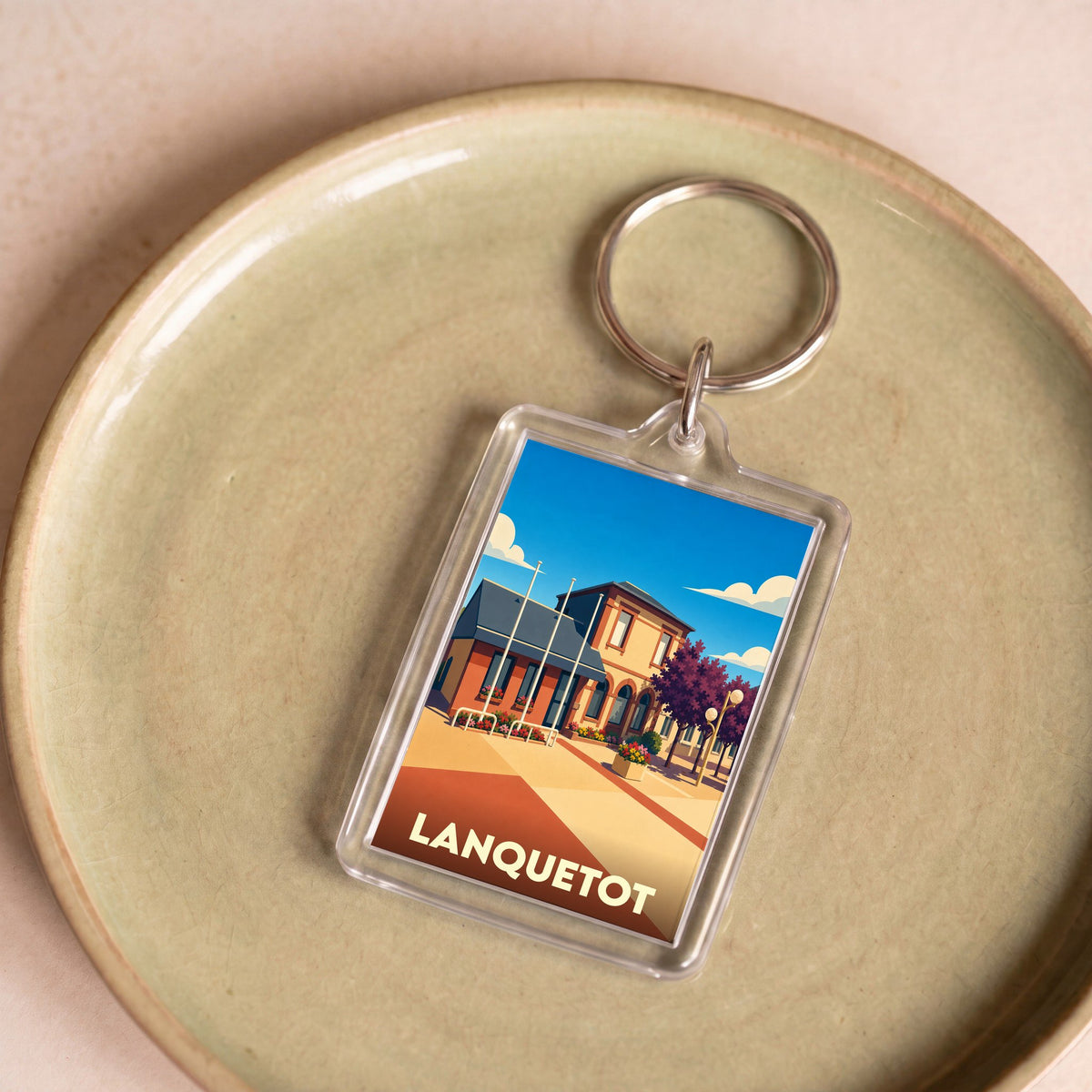 Porte-clés souvenir de la ville de Lanquetot avec une illustration stylisée.