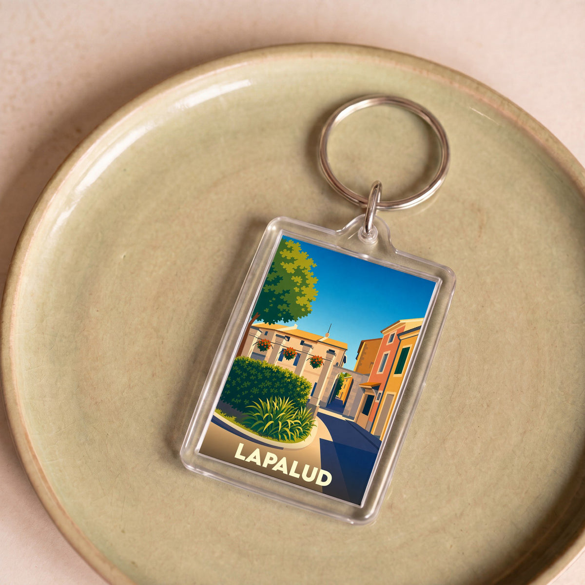 Porte-clés souvenir de la ville de Lapalud avec une illustration stylisée.