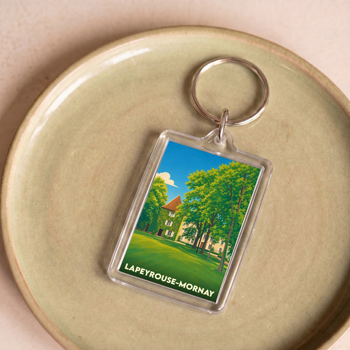 Porte-clés souvenir de la ville de Lapeyrouse-Mornay avec une illustration stylisée.