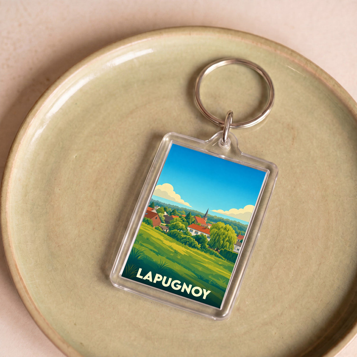 Porte-clés souvenir de la ville de Lapugnoy avec une illustration stylisée.
