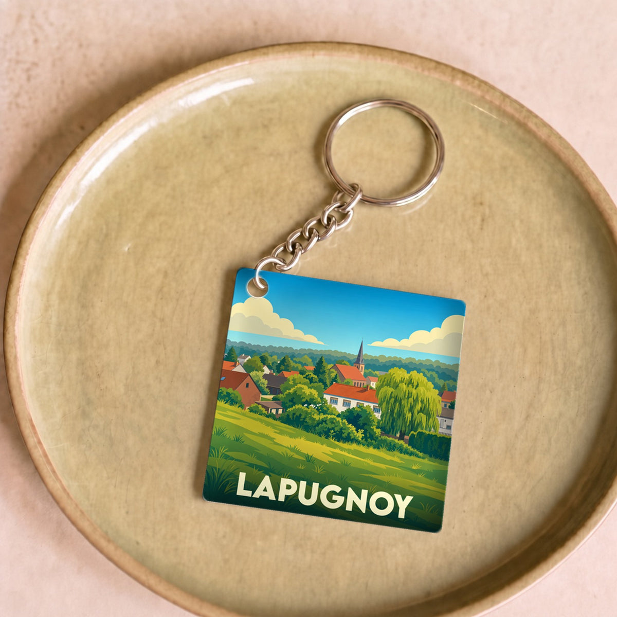 Porte-clés souvenir de la ville de Lapugnoy avec une illustration stylisée.