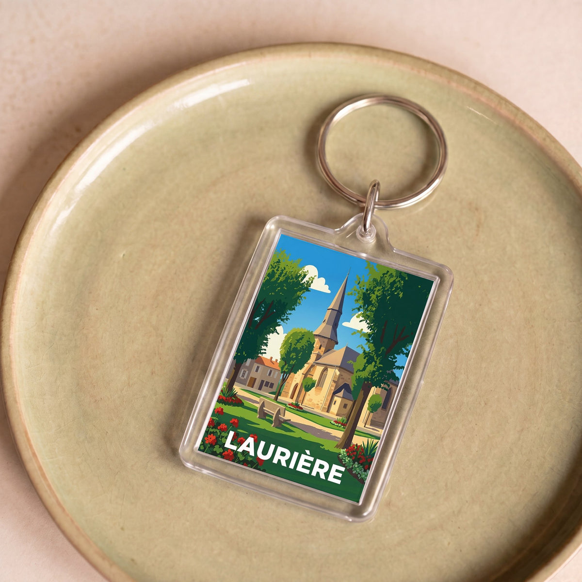 Porte-clés souvenir de la ville de Laurière avec une illustration stylisée.