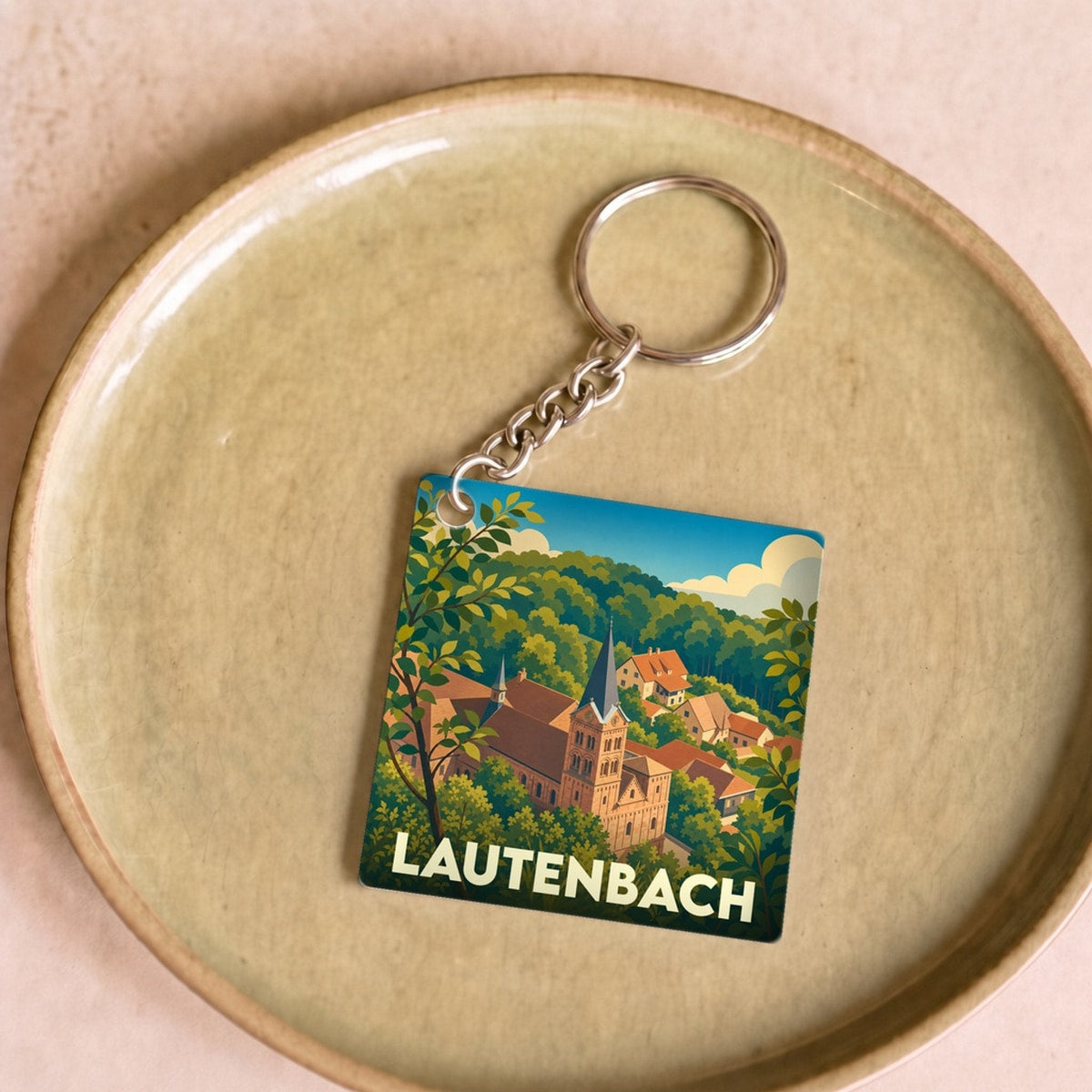 Porte-clés souvenir de la ville de Lautenbach avec une illustration stylisée.