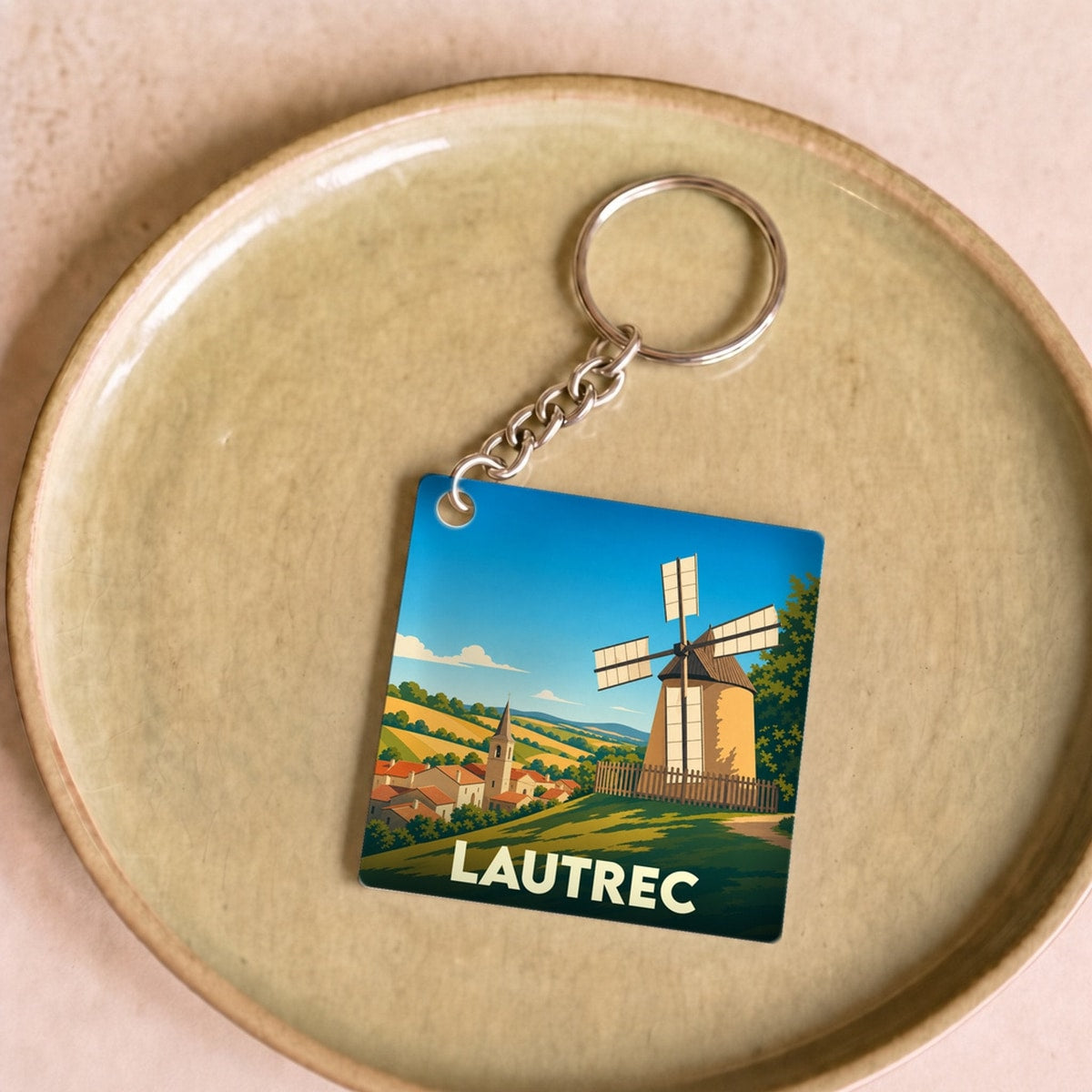 Porte-clés souvenir de la ville de Lautrec avec une illustration stylisée d'un moulin à vent.