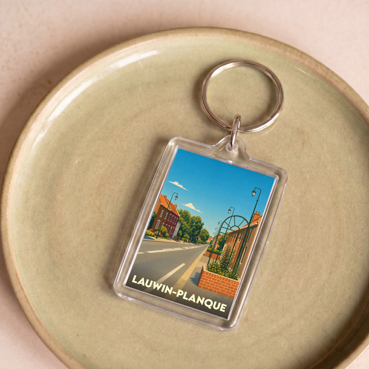 Porte-clés souvenir de la ville de Lauwin-Planque avec une illustration stylisée.