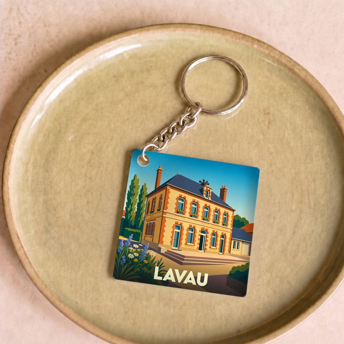 Porte-clés souvenir de la ville de Lavau avec une illustration stylisée d'une bâtisse traditionnelle.