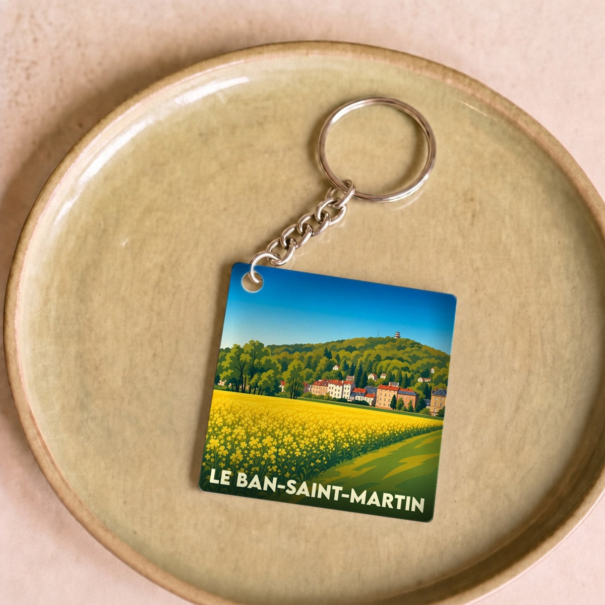 Porte-clés souvenir de la ville du Ban-Saint-Martin avec une illustration stylisée d'un champ fleuri.