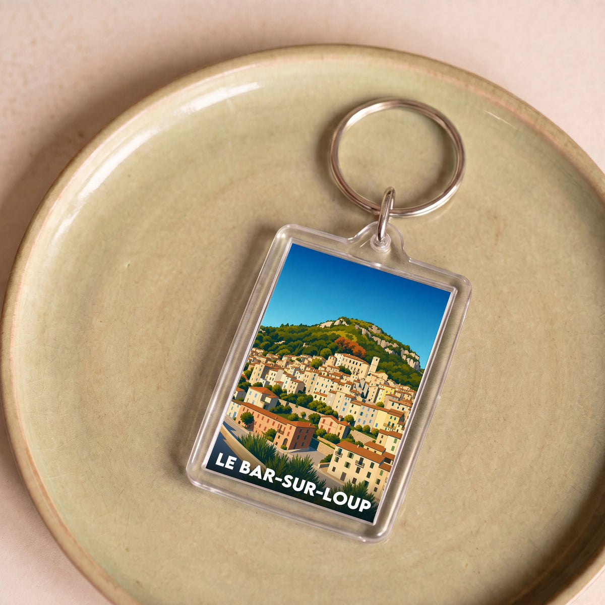 Porte-clés souvenir de la ville de Le Bar-sur-Loup avec une illustration stylisée.