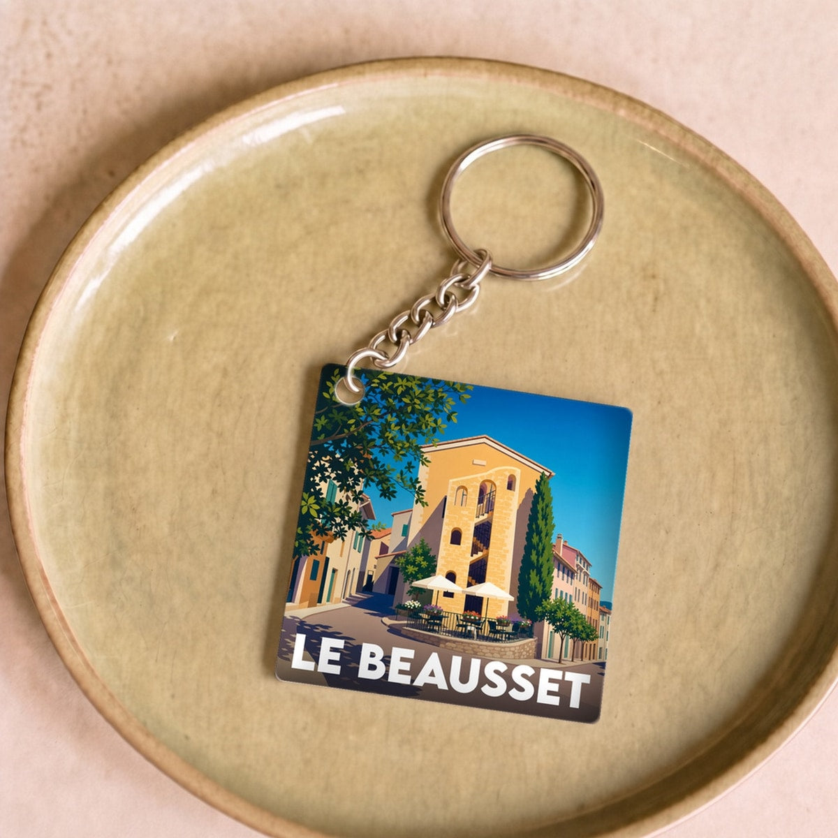 Porte-clés souvenir de la ville du Beausset avec une illustration stylisée.
