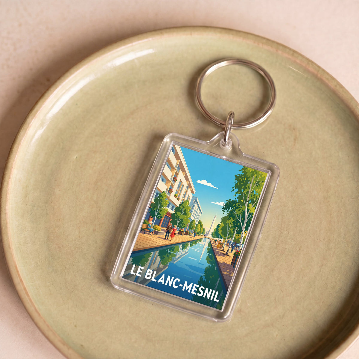 Porte-clés souvenir de la ville de Le Blanc-Mesnil avec une illustration stylisée.