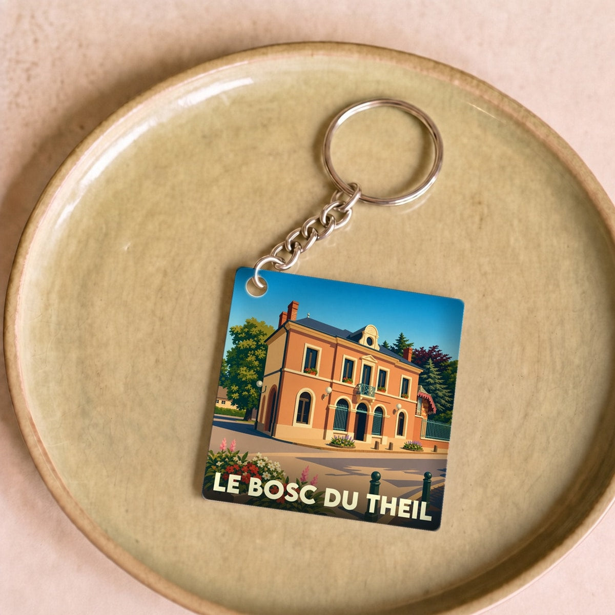 Porte-clés souvenir de la ville de Le Bosc du Theil avec une illustration stylisée.