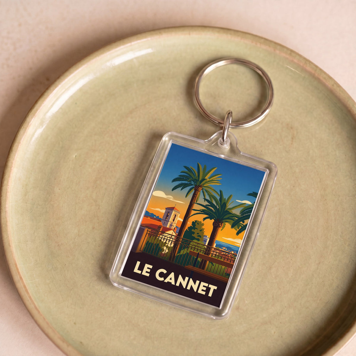 Porte-clés souvenir de la ville de Le Cannet avec une illustration stylisée.