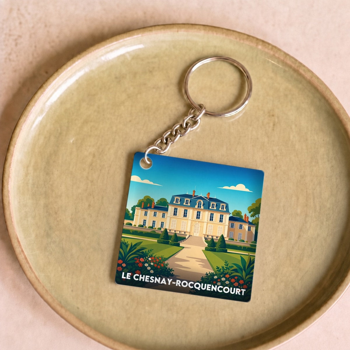 Porte-clés souvenir de la ville de Le Chesnay-Rocquencourt avec une illustration stylisée.