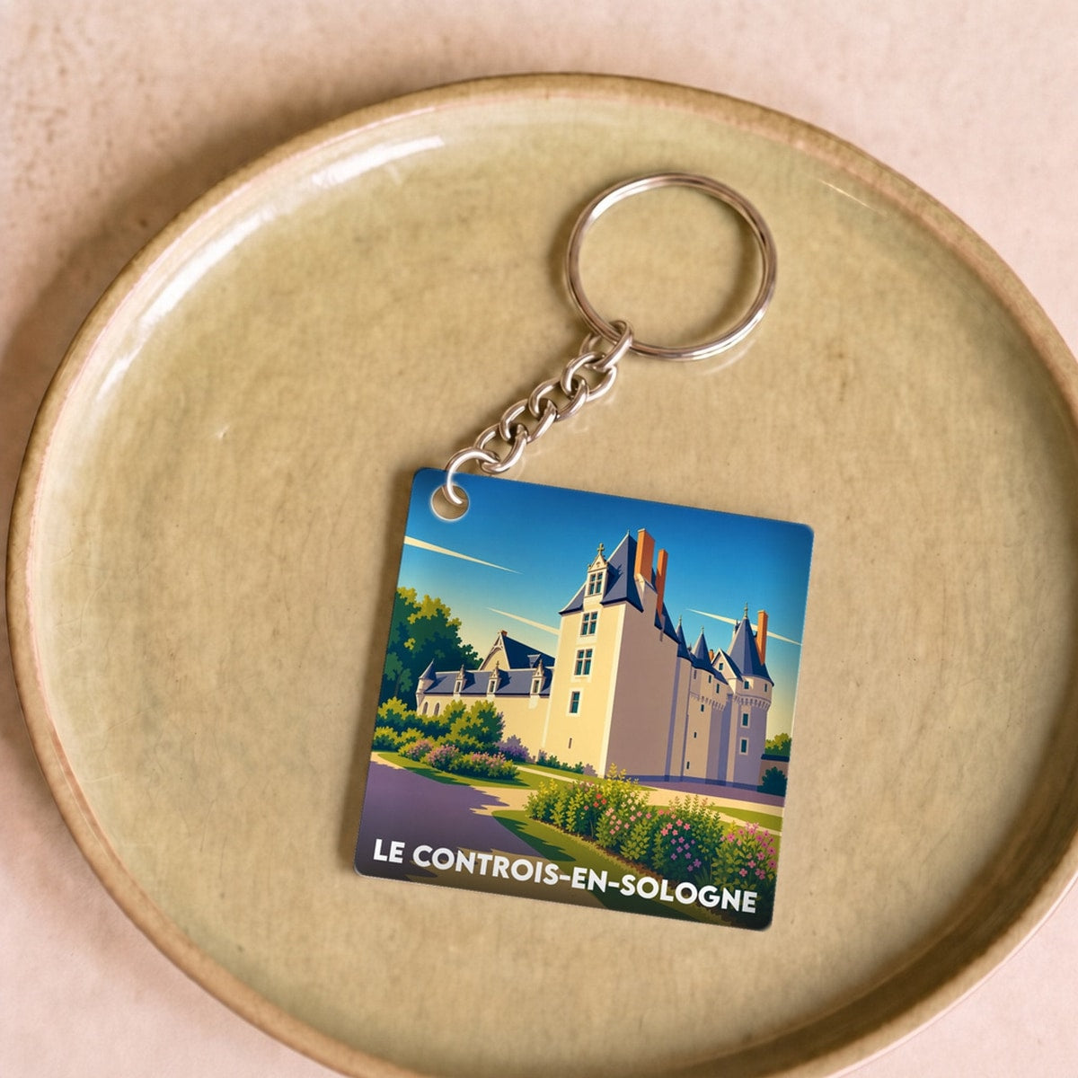 Porte-clés souvenir de la ville du Controis-en-Sologne avec une illustration stylisée de son château.