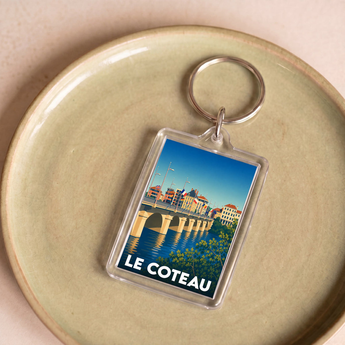 Porte-clés souvenir de la ville de Le Coteau avec une illustration stylisée.