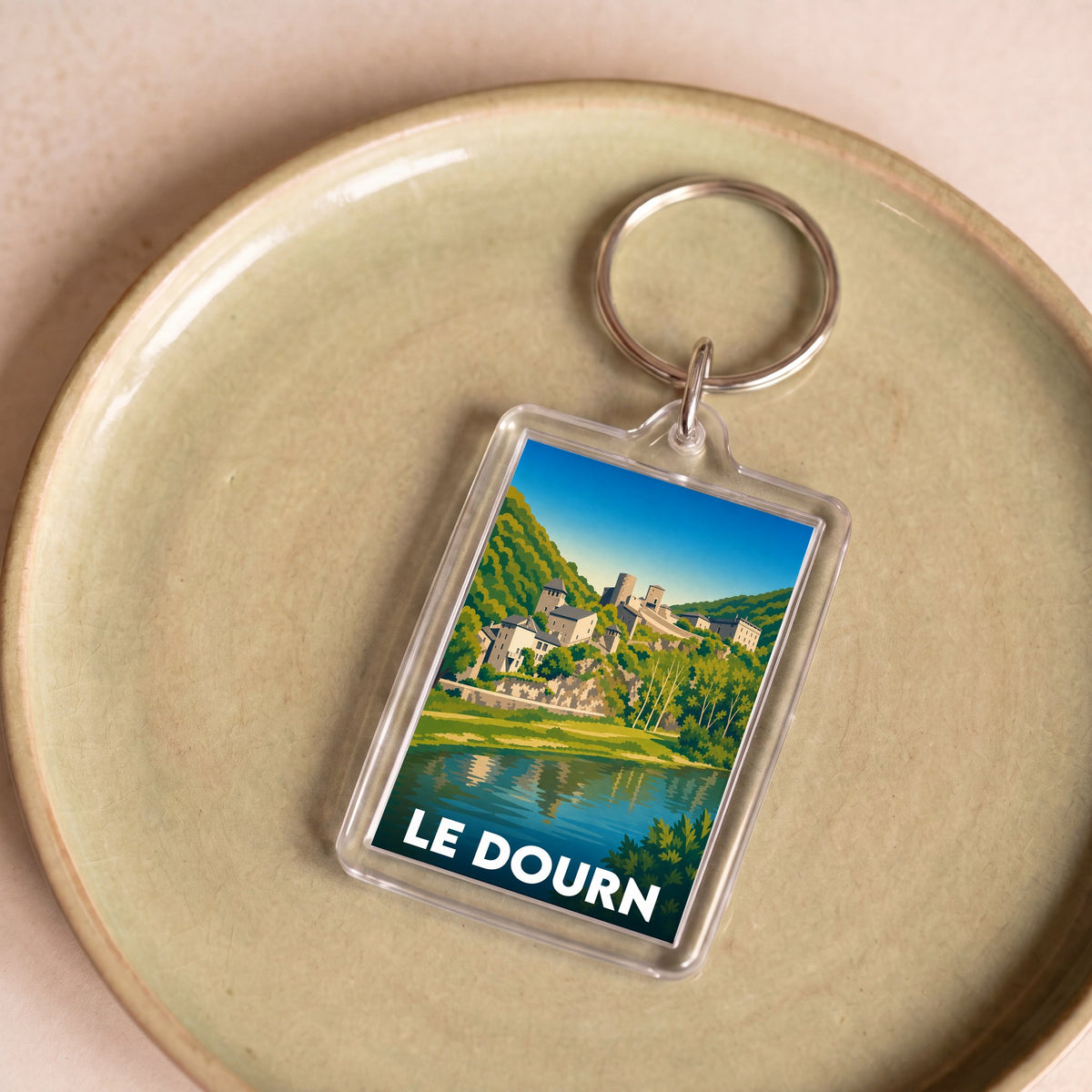 Porte-clés souvenir de la ville de Le Dourn avec une illustration stylisée.