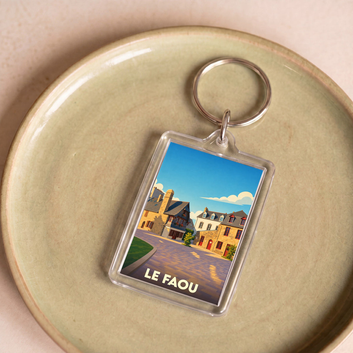 Porte-clés souvenir de la ville de Le Faou avec une illustration stylisée.