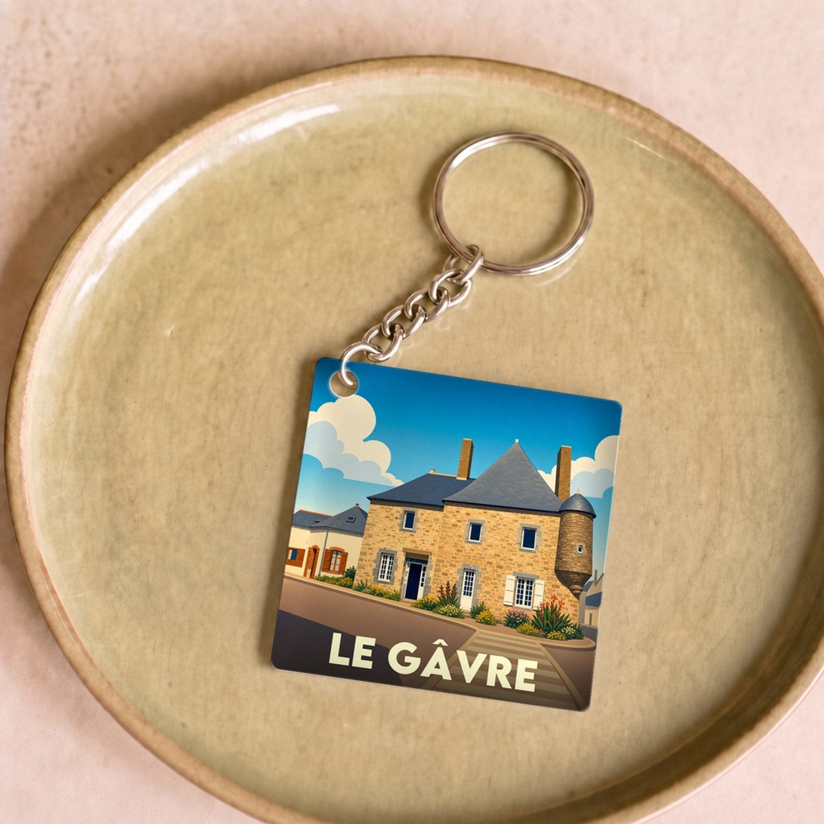 Porte-clés souvenir de la ville du Gâvre avec une illustration stylisée d'un bâtiment historique.
