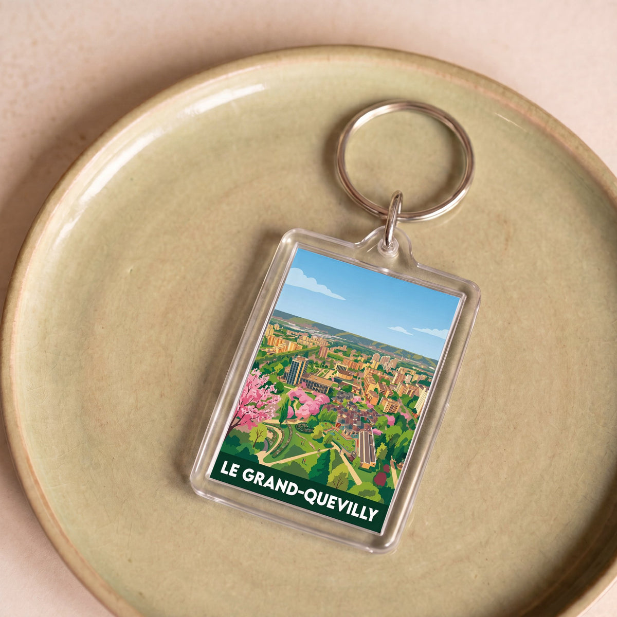Porte-clés souvenir de la ville de Le Grand-Quevilly avec une illustration stylisée.