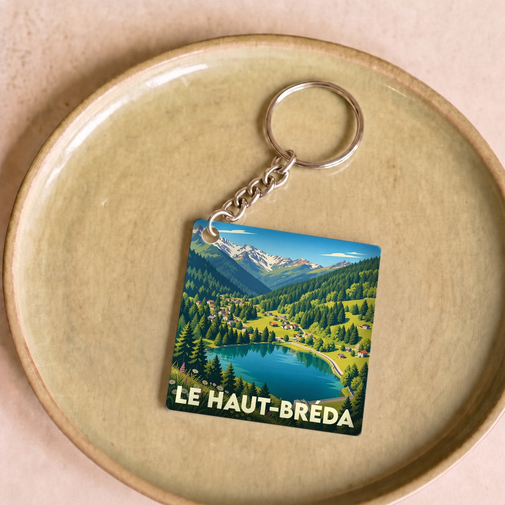 Porte-clés souvenir de la ville de Le Haut-Bréda avec une illustration stylisée d'un paysage de montagne et d'un lac.
