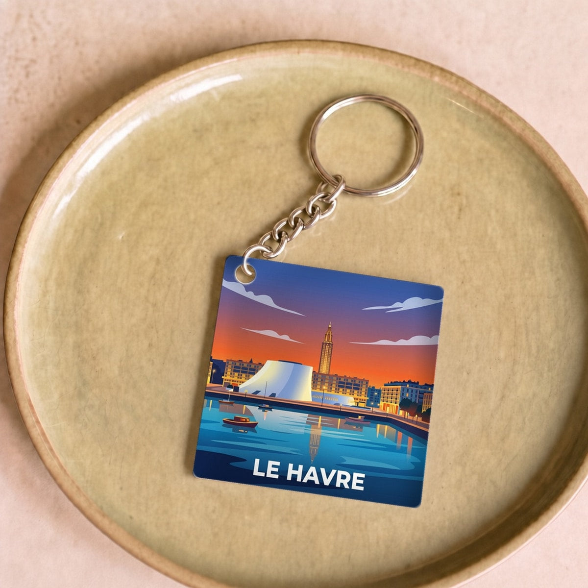 Porte-clés souvenir de la ville du Havre avec une illustration stylisée.
