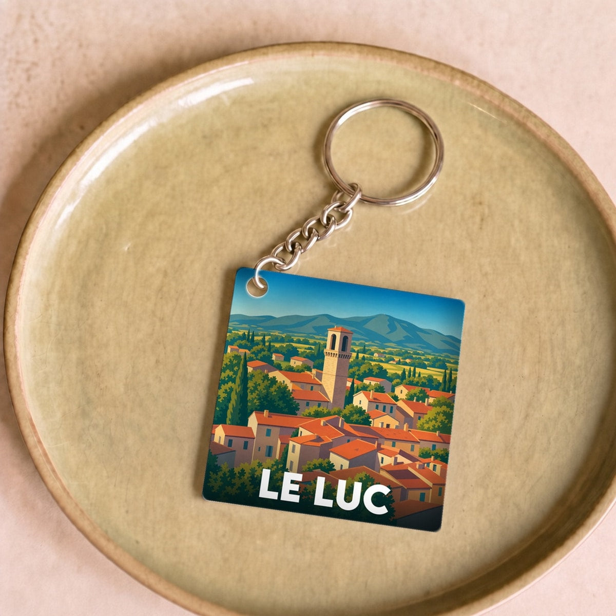 Porte-clés souvenir de la ville de Le Luc avec une illustration stylisée.