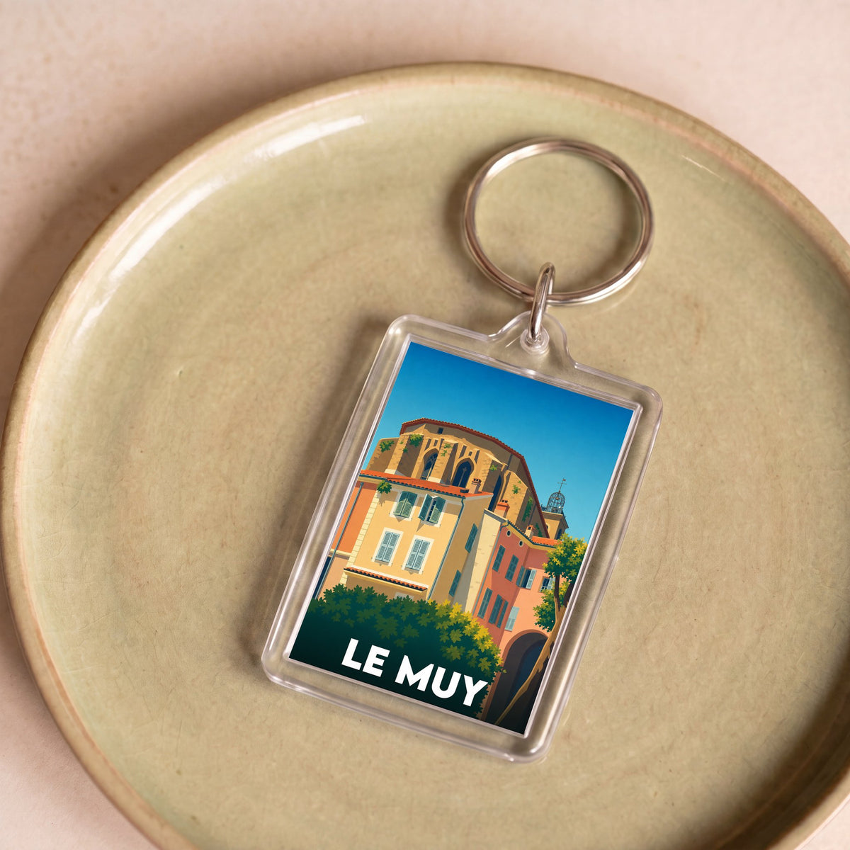 Porte-clés souvenir de la ville de Le Muy avec une illustration stylisée et colorée.