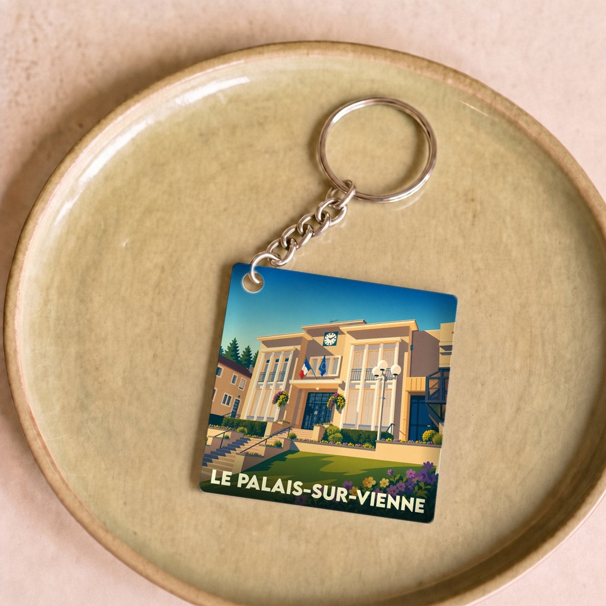 Porte-clés souvenir de la ville de Le Palais-sur-Vienne avec une illustration stylisée de son hôtel de ville.