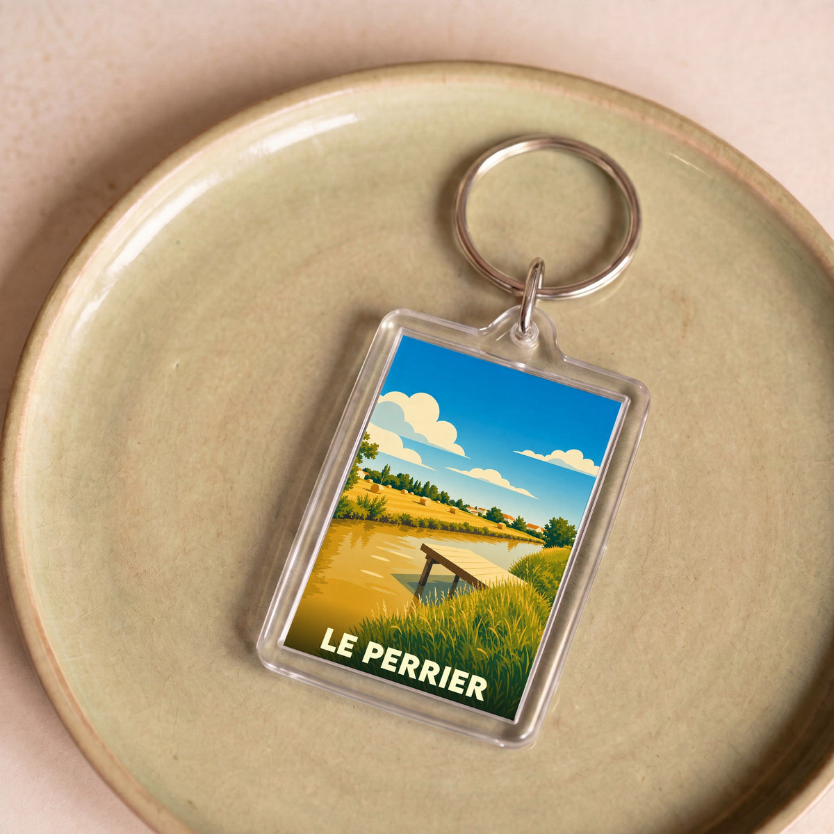 Porte-clés souvenir de la ville du Perrier avec une illustration stylisée de marais.