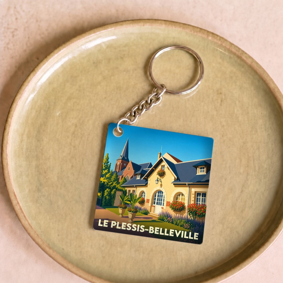 Porte-clés souvenir de la ville de Le Plessis-Belleville avec une illustration colorée et stylisée.