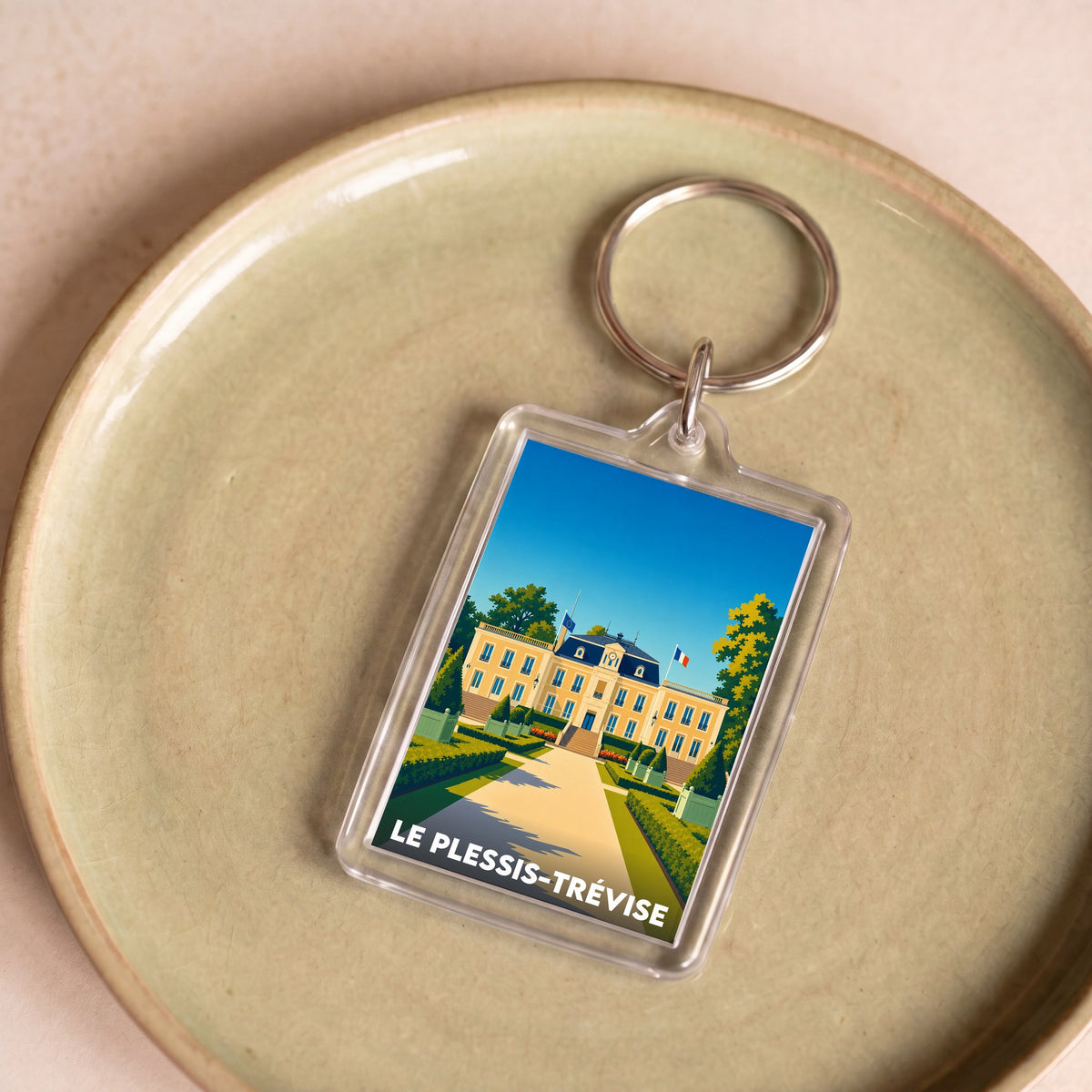 Porte-clés souvenir de la ville de Le Plessis-Trévise avec une illustration stylisée.