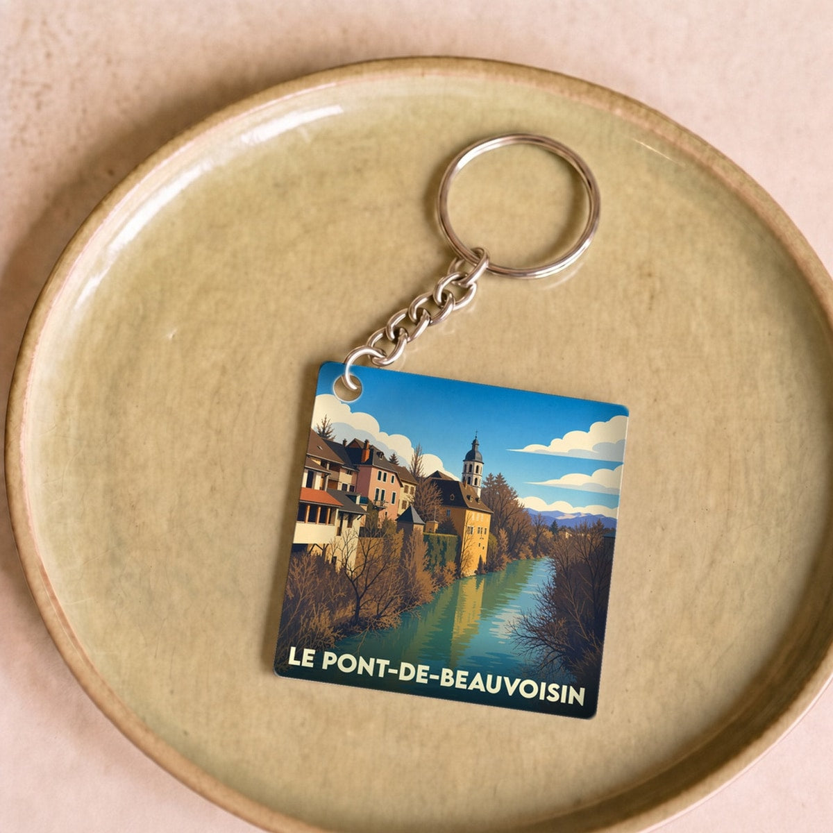 Porte-clés souvenir de la ville de Le Pont-de-Beauvoisin avec une illustration stylisée.