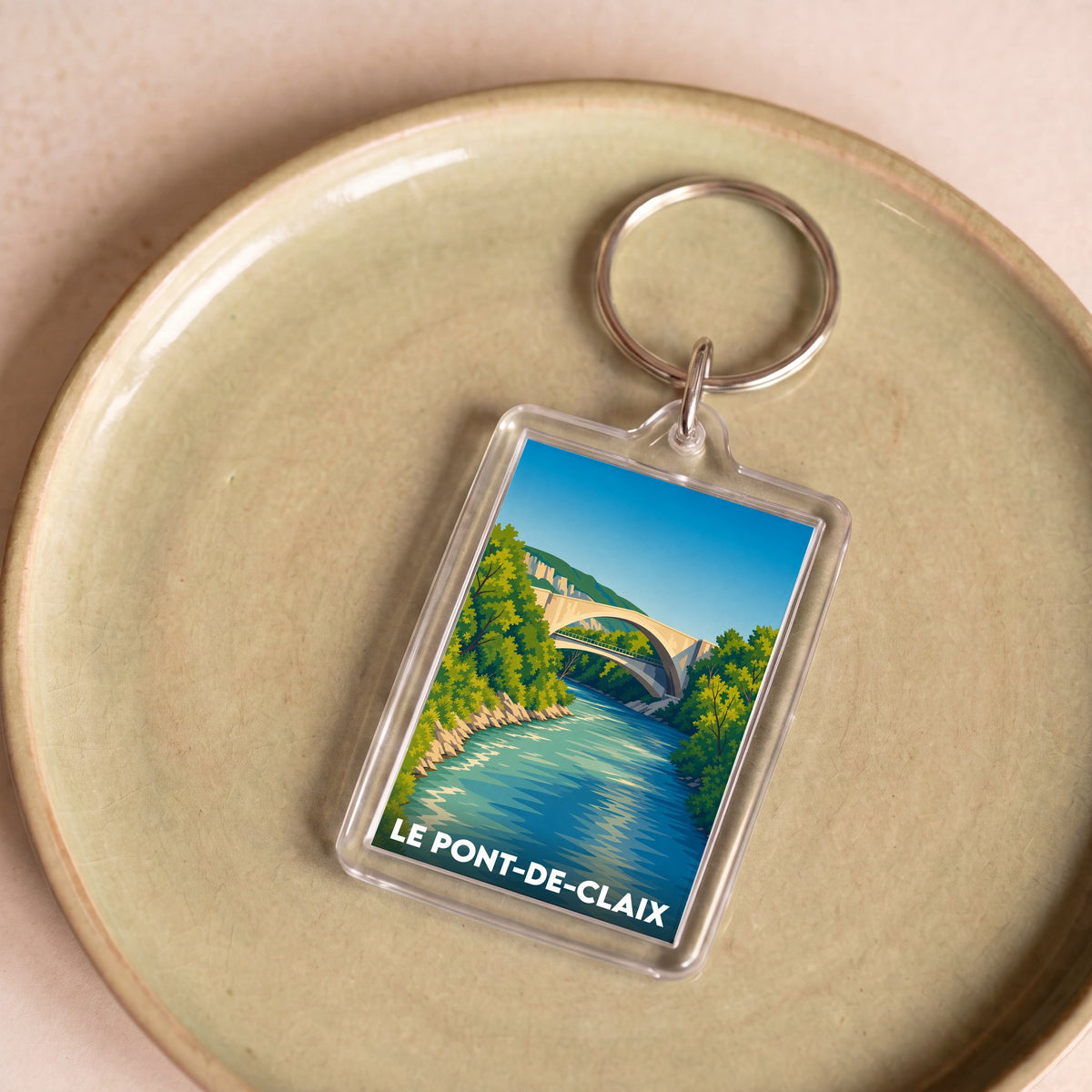 Porte-clés souvenir de la ville de Le Pont-de-Claix avec une illustration stylisée.