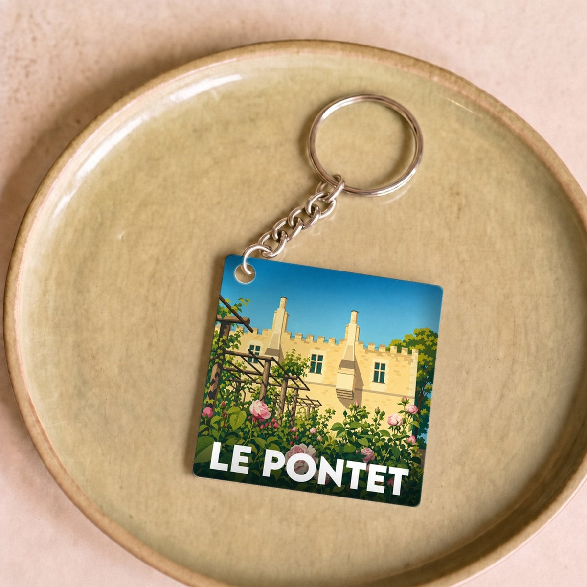Porte-clés souvenir de la ville de Le Pontet avec une illustration stylisée.