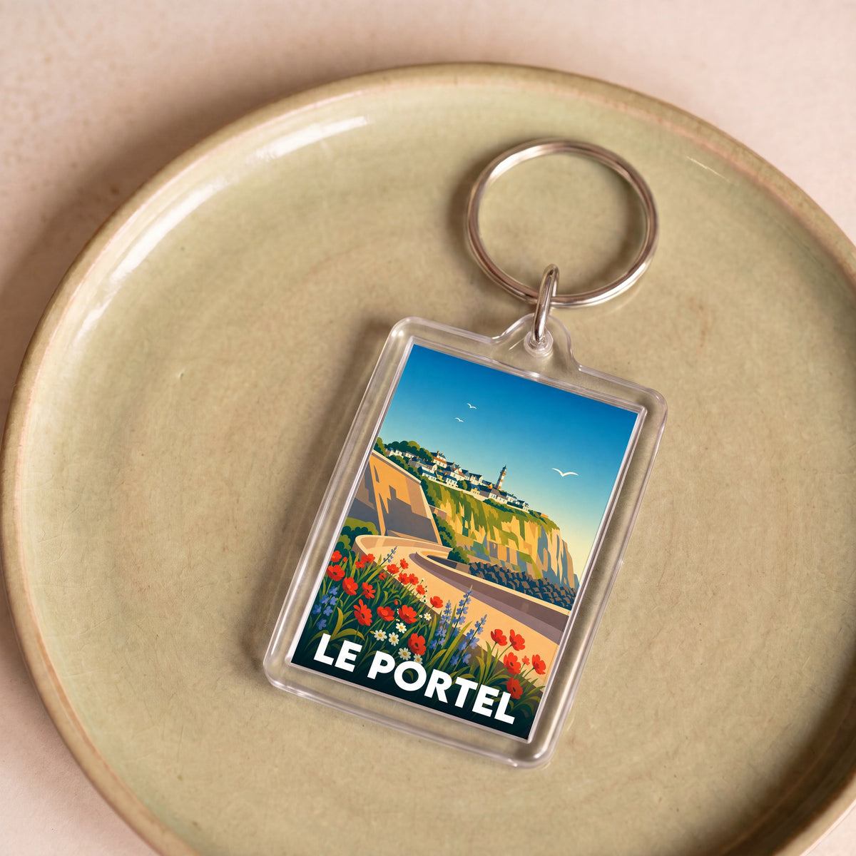 Porte-clés souvenir de la ville de Le Portel avec une illustration stylisée.
