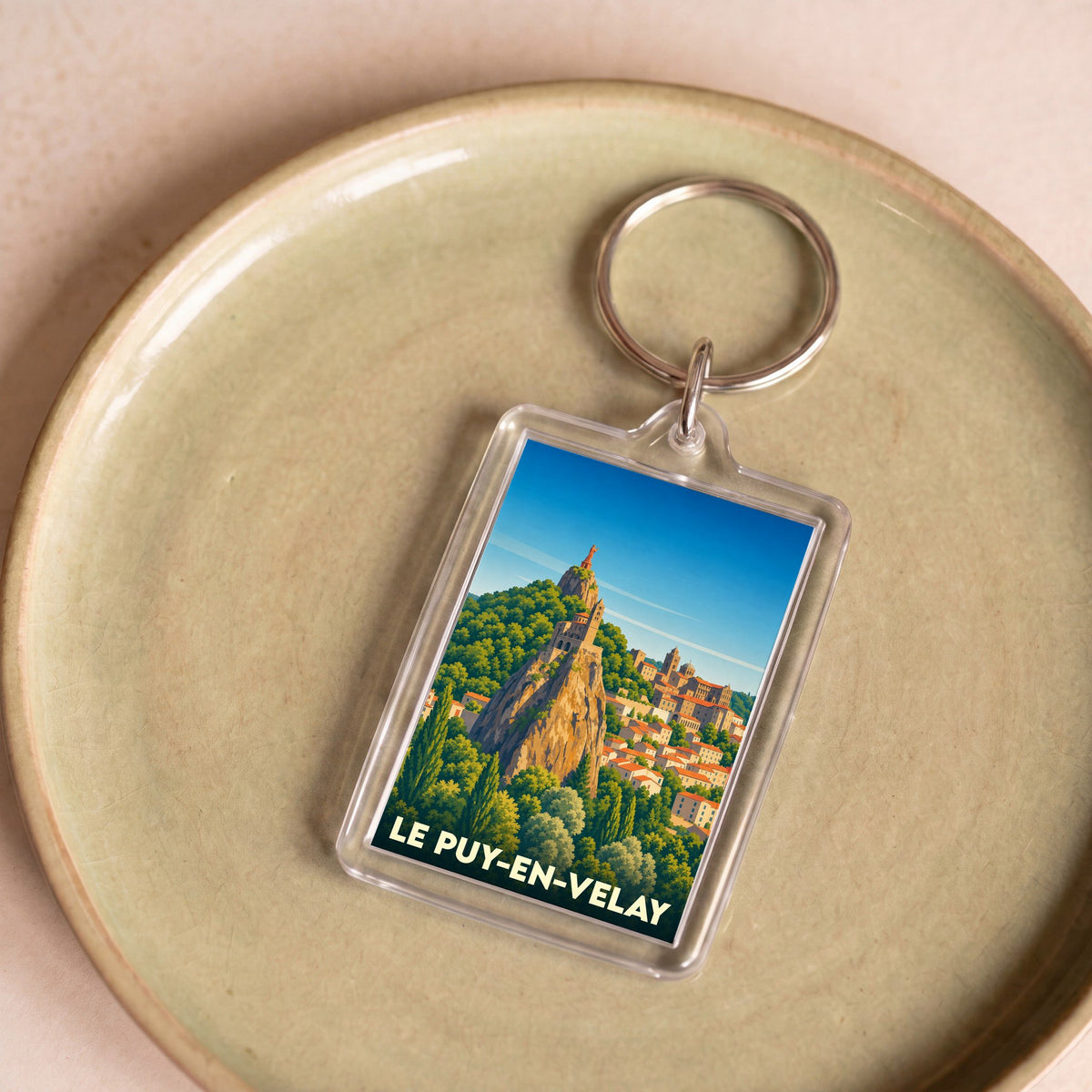Porte-clés souvenir de la ville de Le Puy-en-Velay avec une illustration stylisée de son rocher emblématique.