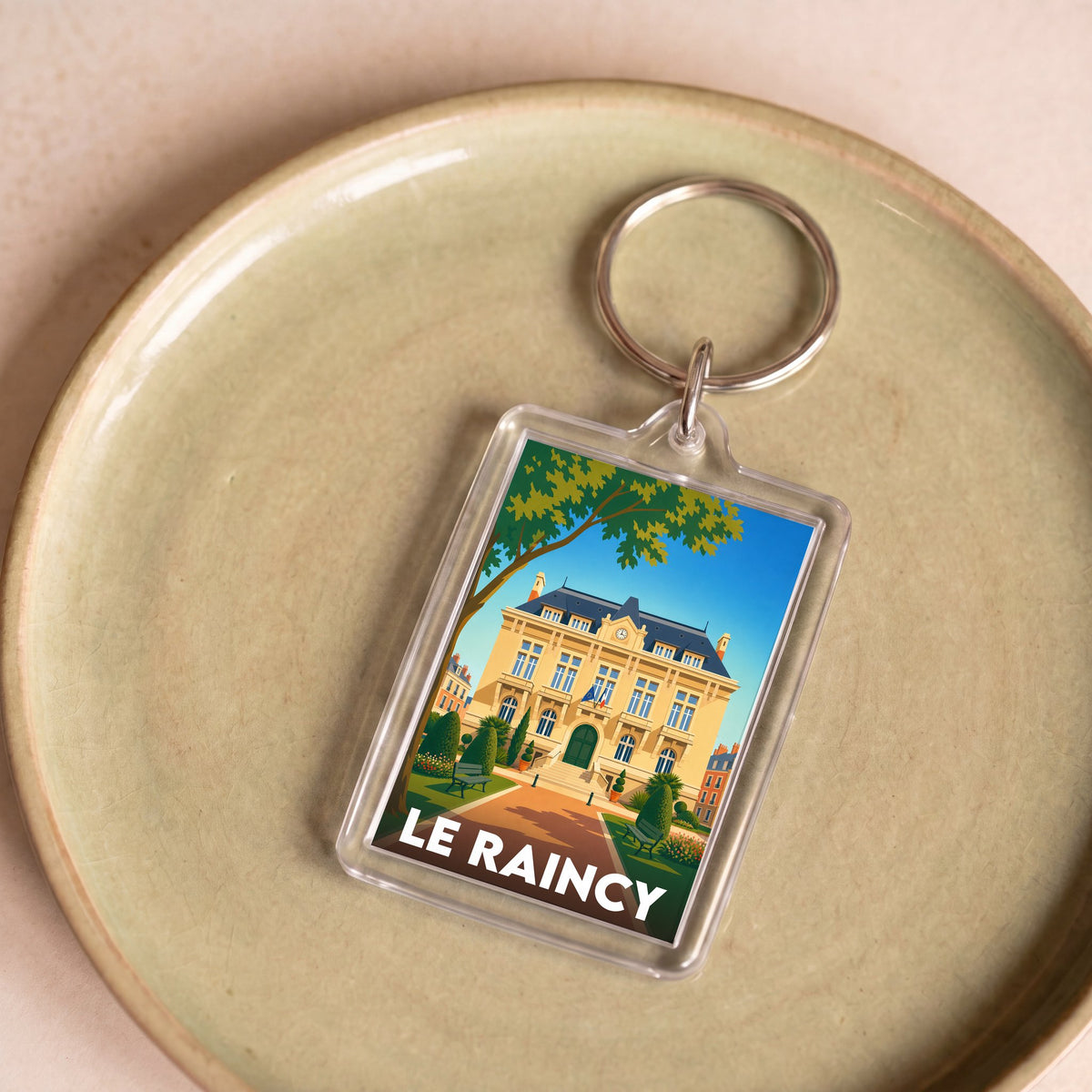Porte-clés souvenir de la ville de Le Raincy avec une illustration stylisée.