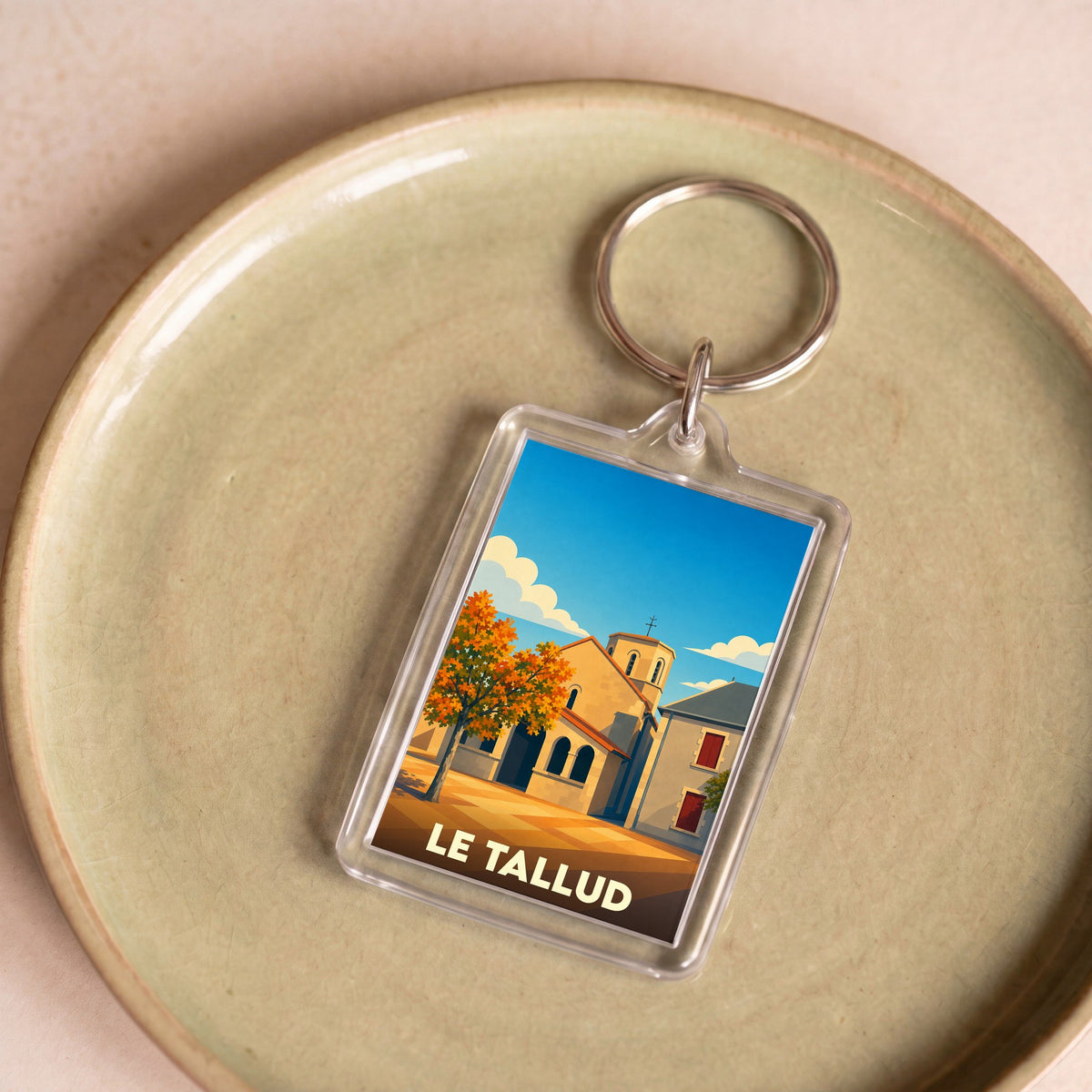 Porte-clés souvenir de la ville de Le Tallud avec une illustration stylisée.