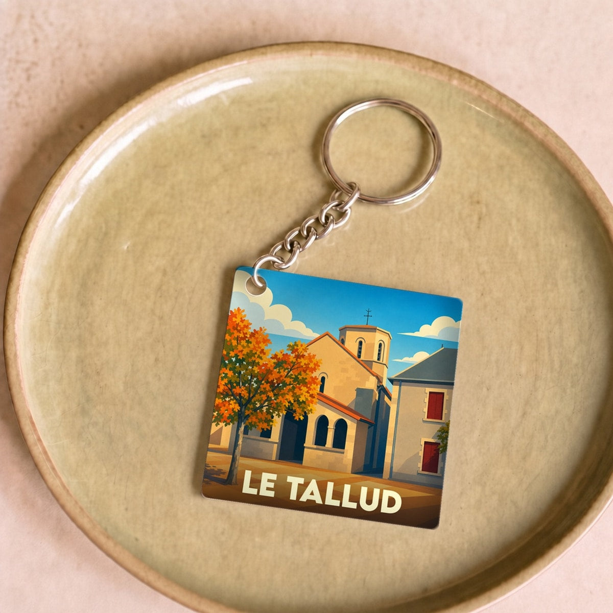 Porte-clés souvenir de la ville de Le Tallud avec une illustration stylisée.