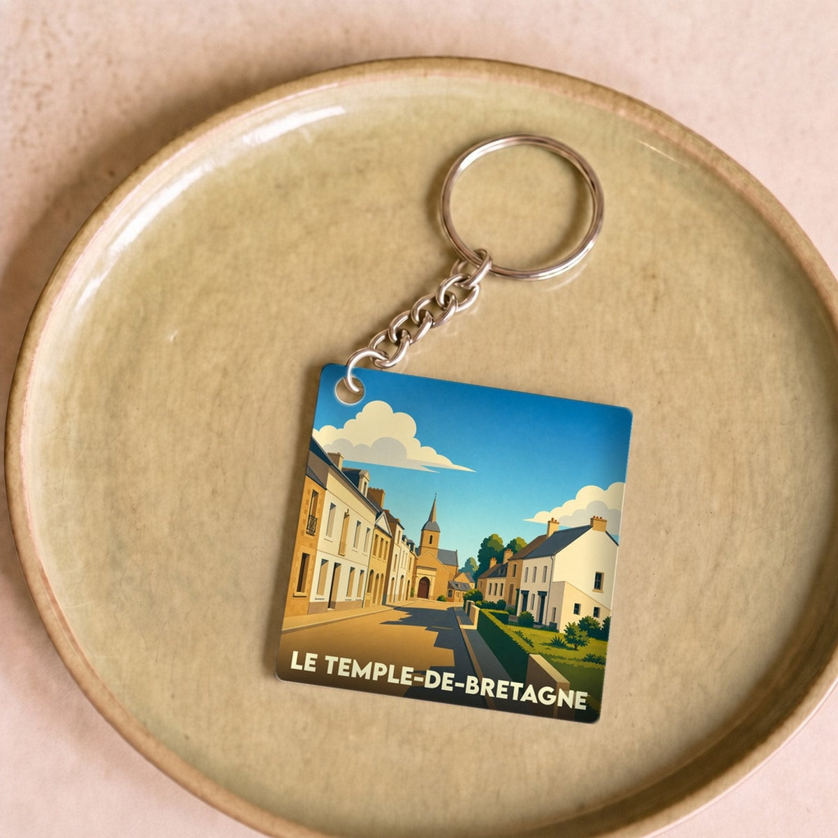 Porte-clés souvenir de la ville de Le Temple-de-Bretagne avec une illustration stylisée.