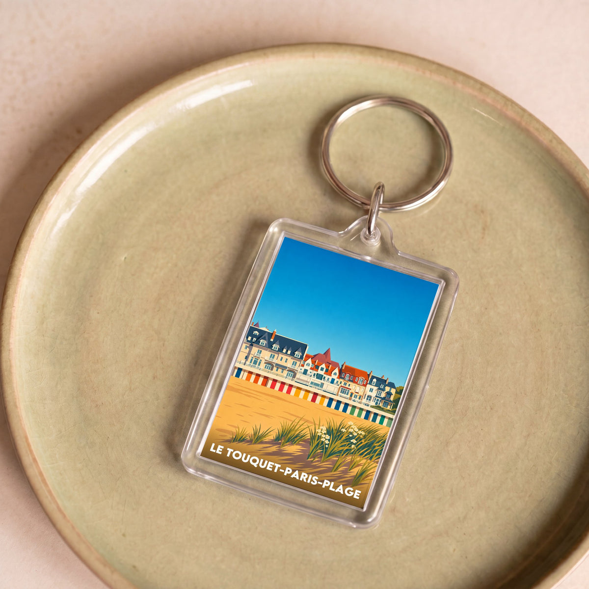 Porte-clés souvenir de la ville de Le Touquet-Paris-Plage avec une illustration stylisée de son front de mer.